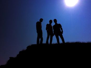 Low angle view of silhouette people against sky