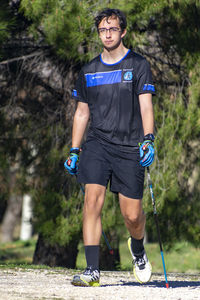Portrait of young man standing in park