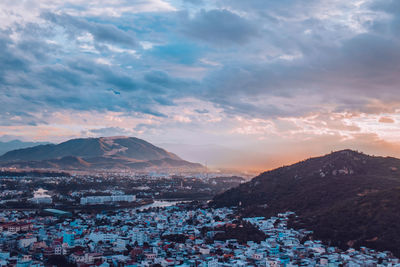 Aerial view of townscape against sky during sunset