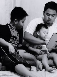 Father and daughter playing with baby at home