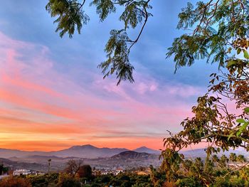 Scenic view of mountains against sky at sunset