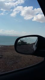 Reflection on side-view mirror of car