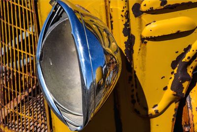 Close-up of yellow tractor with headlight