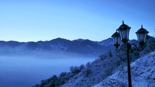 Scenic view of snowcapped mountains against clear blue sky