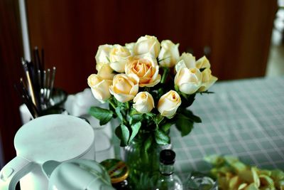 Close-up of white roses in vase on table