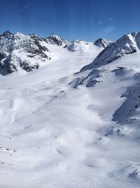 Scenic view of snow covered mountains against sky