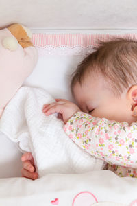 Cute baby sleeping on bed
