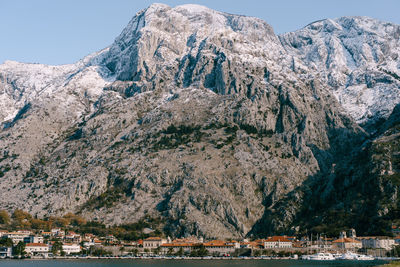 Panoramic shot of sea by mountain against sky