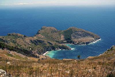 High angle view of sea and mountains against sky