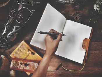 Close-up high angle view of hand on table