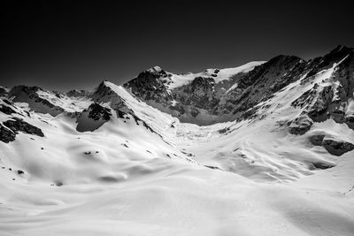 Scenic view of snowcapped mountains against clear sky