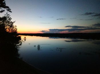 Scenic view of lake against sky at sunset