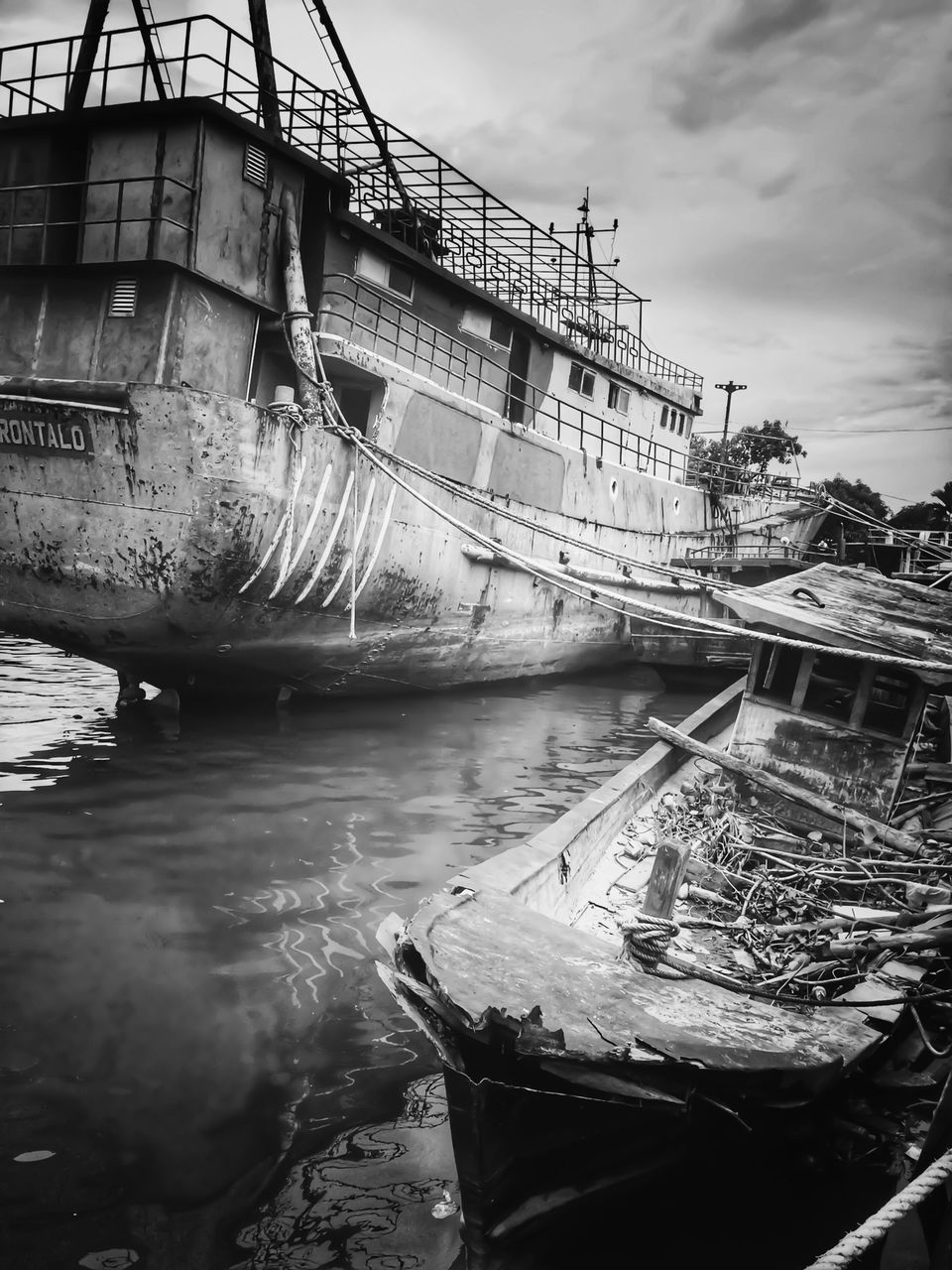 ABANDONED BOAT MOORED IN WATER