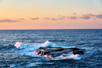 View of sea against sky during sunrise