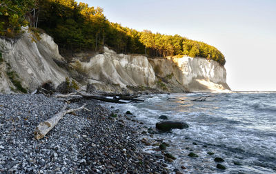 Rocks on beach against sky