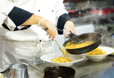 Midsection of man preparing food