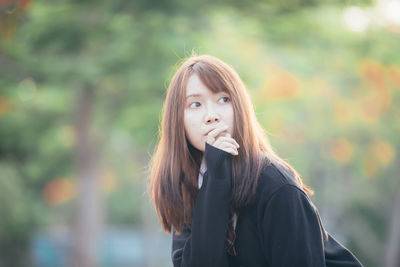 Portrait of young woman standing outdoors