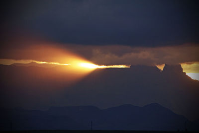 Scenic view of mountains against sky at sunset