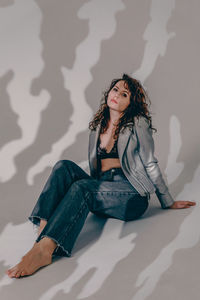 Young woman sitting on sofa at home