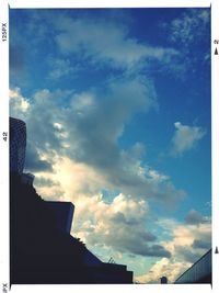 Low angle view of building against cloudy sky