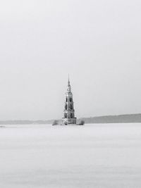 View of building by sea against sky