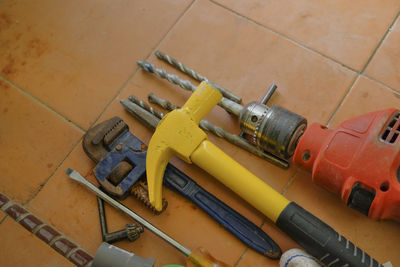 High angle view of work tools on tiled floor