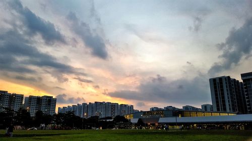 View of cityscape against dramatic sky