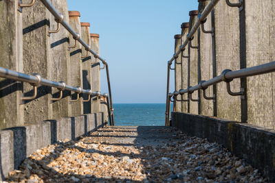 Wooden railings leading onto the pebbled beach in eastbourne
