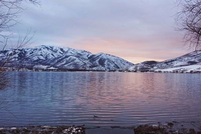 Scenic view of lake against sky during winter