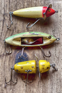 High angle view of yellow fishing on wooden table