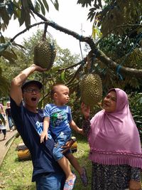 Full length of father and son against plants