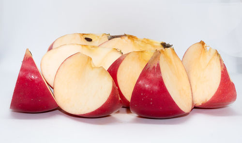 Close-up of apples on table against white background