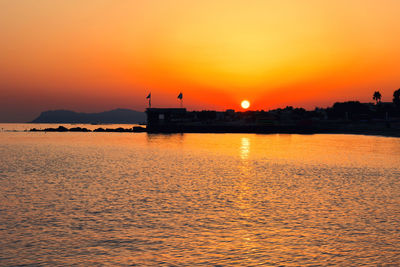 Scenic view of sea against orange sky at sunrise crete