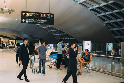 Group of people walking on railroad station platform