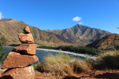 Scenic view of lake and mountains against blue sky