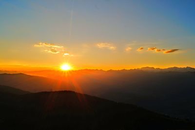 Scenic view of silhouette mountains against sky during sunset