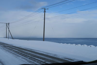 Bridge over sea against sky during winter