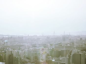 High angle view of buildings in city against sky