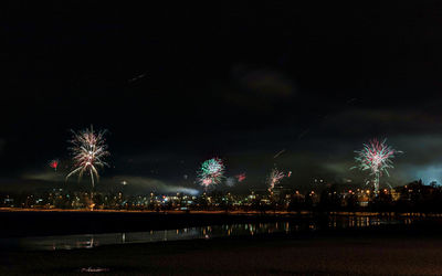 Low angle view of firework display at night