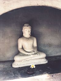 Statue of buddha against building