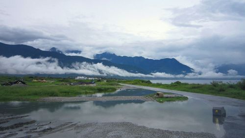 Scenic view of mountains against cloudy sky