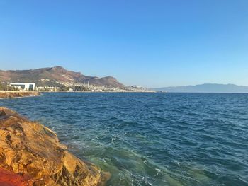 Scenic view of sea against clear blue sky