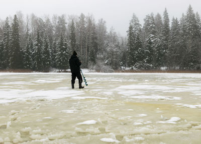 Rear view of woman standing in water