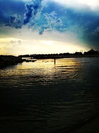 Scenic view of lake against sky at sunset