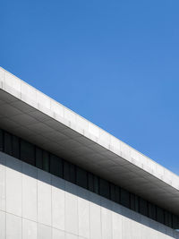 Low angle view of building against clear blue sky
