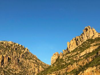 Scenic view of mountains against clear blue sky