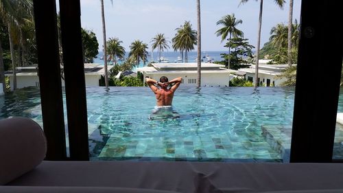 Man in swimming pool against sky