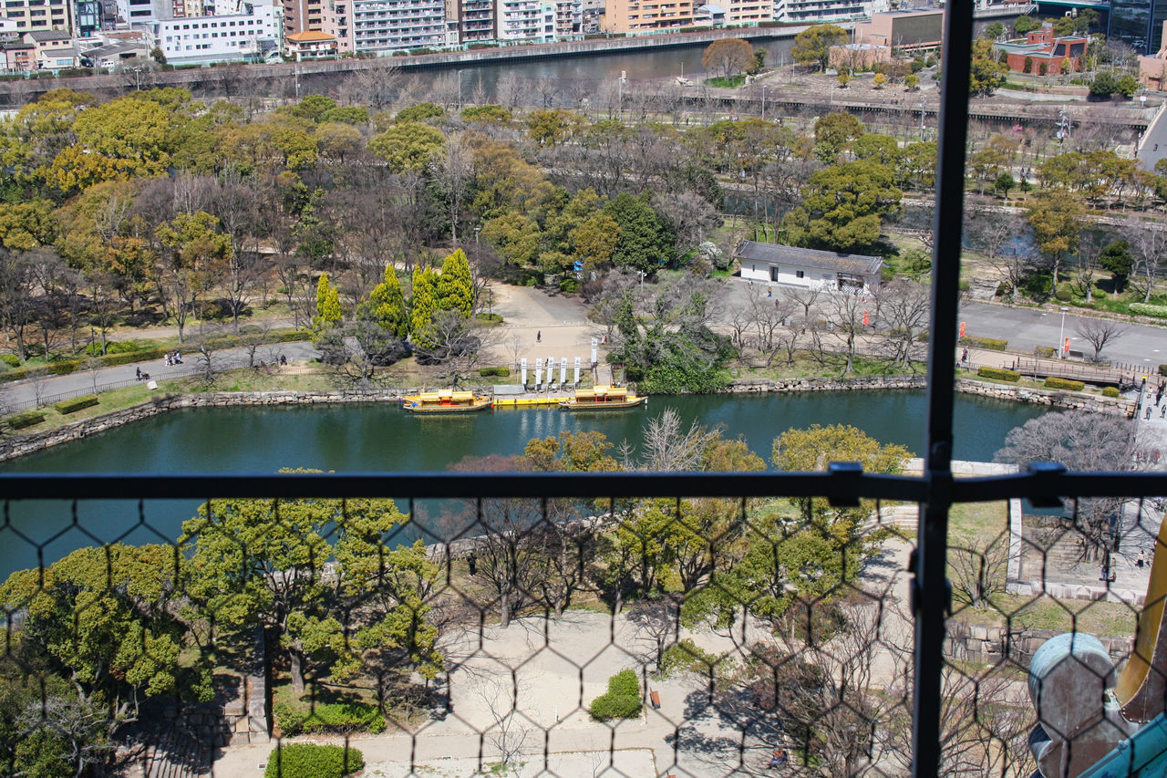 HIGH ANGLE VIEW OF RIVER AMIDST BUILDINGS