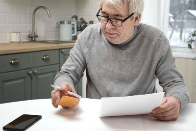 Portrait of senior man using mobile phone