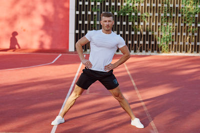 Rear view of man exercising on court